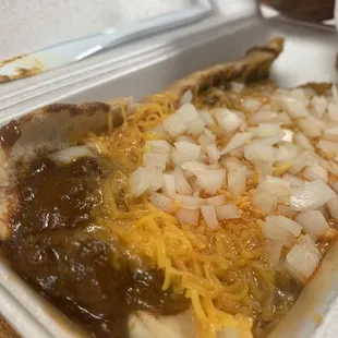 a hot dog with onions and cheese