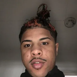 a man with a messy top knot