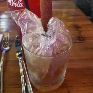 a glass of coke and a spoon