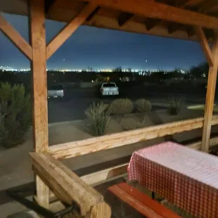 Standing outside on the open porch.