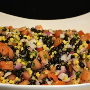 a bowl of black beans, corn, and tomatoes