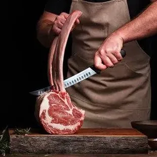 a man slicing a steak