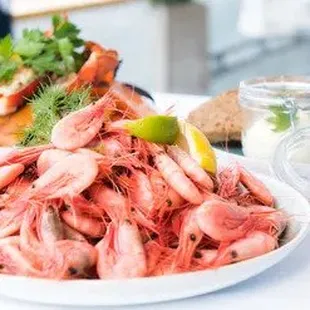 a plate of shrimp and a sandwich