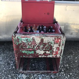 an old coca cola cooler