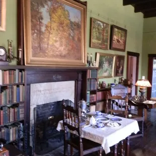 Living Room filled with books, paintings, and antiques