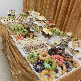 a table full of donuts and cupcakes