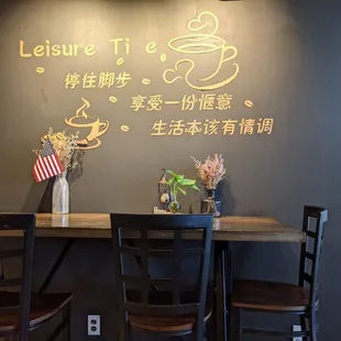 a table with chairs and a vase of flowers