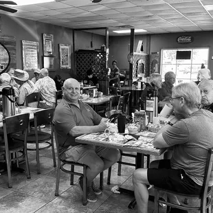 a black and white photo of diners