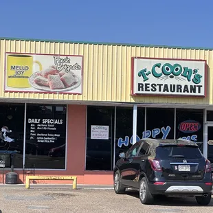 cars parked in front of a restaurant