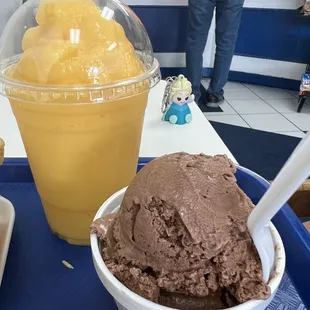 a bowl of ice cream and a cup of orange juice