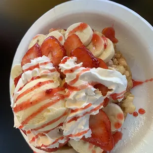 Strawberry/banana crepe with vanilla ice cream, whipped cream and strawberry sauce