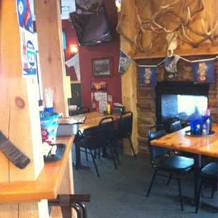 a bar with a television and a fireplace