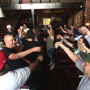 a large group of people toasting