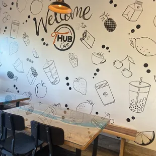 One side of the wall, with tables and seating.