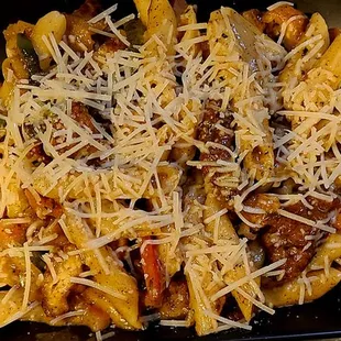  a tray of pasta with sausage and cheese