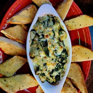  a bowl of spinach and cheese dip