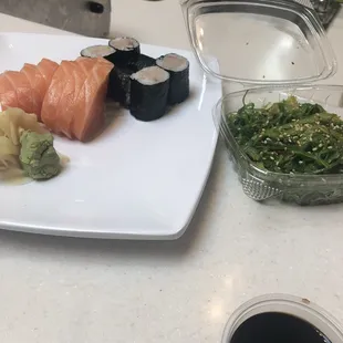 2 orders of salmon sashimi, one yellowtail roll and seaweed salad.