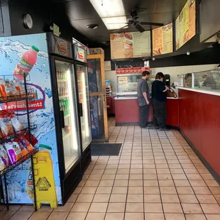 a man and a woman standing at the counter