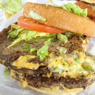 a hamburger with lettuce, tomato, and cheese