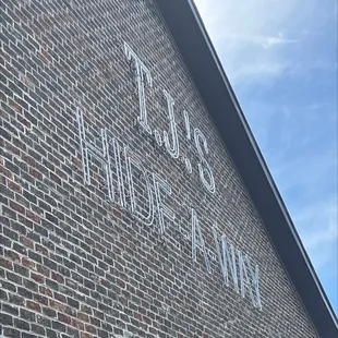 a brick building with a sign on it