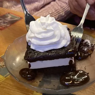a slice of cake with whipped cream on top
