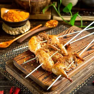 skewer of chicken on a wooden board
