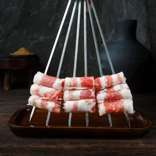 bunch of meat wrapped in strips