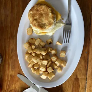 Egg and cheese biscuit and side of home fries.
