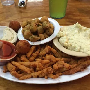 Fried clams, potato salad, fried okra, and hush puppies.