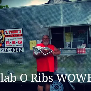a man standing in front of a food truck