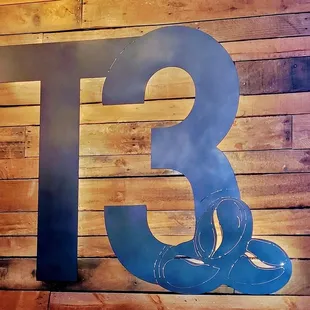 the number three on a wooden wall