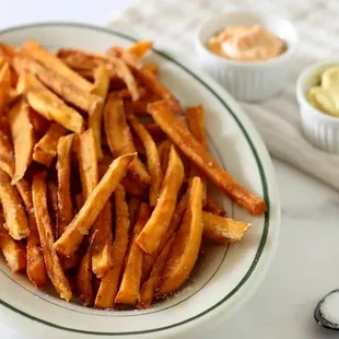 a bowl of french fries and a spoon