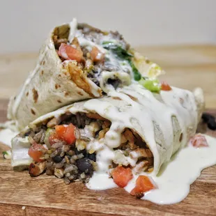 Burrito: Flour tortilla, choice of meat, rice, black beans, shredded cheese, lettuce, tomato and melted cheese.