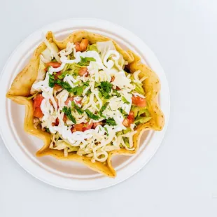 Taco Salad: Hard shell bowl, choice of meat, black beans, lettuce, tomato, cheese and sour cream.