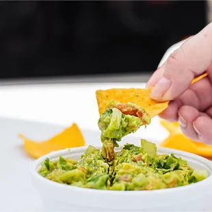 Fresh Guacamole: Homemade fried corn chips with chopped avocado, onions, tomato and cilantro.