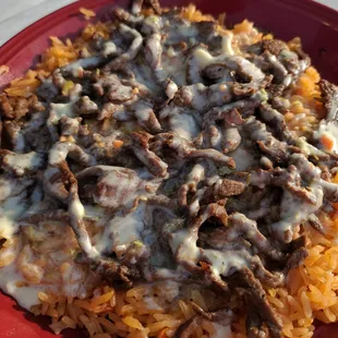 Arroz con Carne - ACC: Grilled steak, rice and melted cheese.