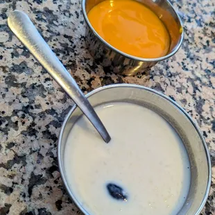 two bowls of soup and a spoon
