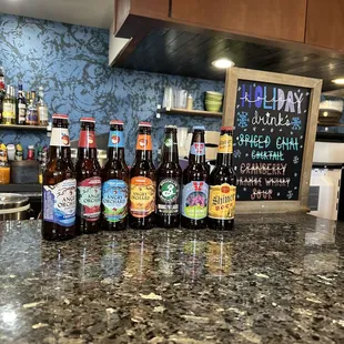 a variety of beer bottles on a counter