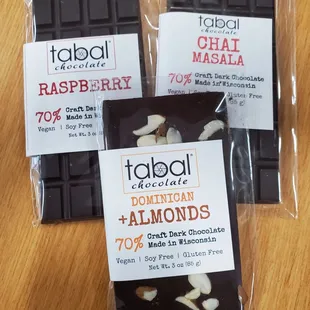 three bars of dark chocolate with almonds