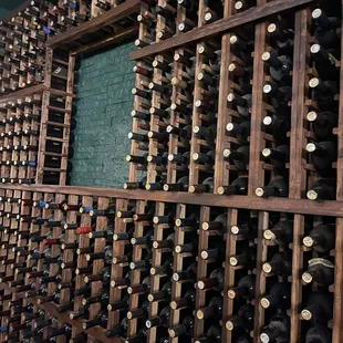 a wall of wine bottles in a wine cellar