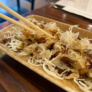 Takoyaki Balls hiding under the Bonito Flakes. Zoom in.