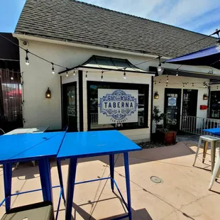 a patio area with tables and umbrellas
