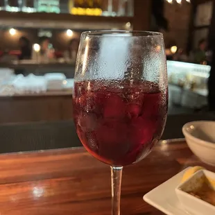 a glass of wine on a bar