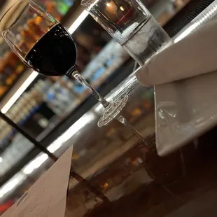 two glasses of wine on a bar