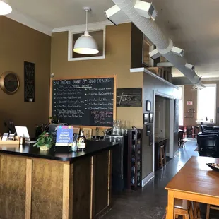 View of inside front desk and chalkboard that features monthly events.