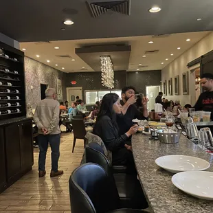 a group of people sitting at a bar