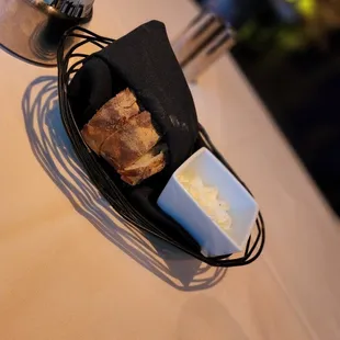 a basket of bread and butter on a table