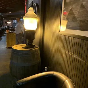 a lamp on a barrel in a restaurant