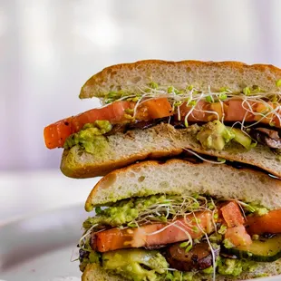 Avocado Veggie Sandwich (V) | Toasted ciabatta, avocado, marinated sliced tomatoes, pickles, cremini mushrooms, alfalfa sprouts, vegan aioli