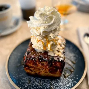 a piece of cake with whipped cream on top